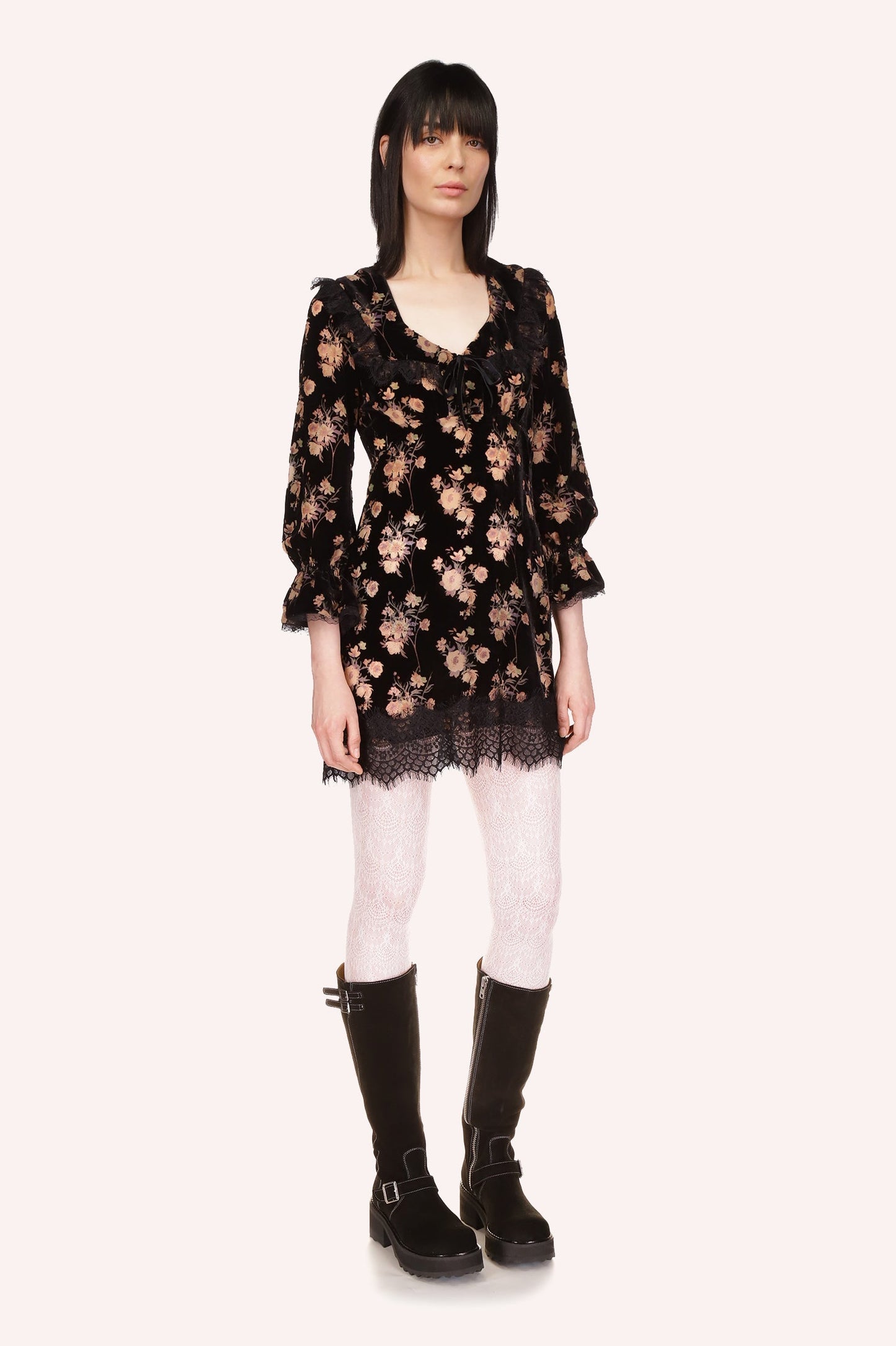 Floral dress with V-neck collar, black lace accents, and long sleeves on black background
