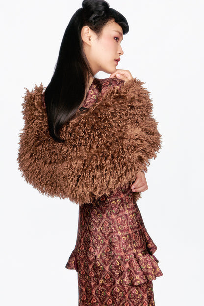 Woman wearing a Wallpaper Medley Maxi Dress, fall colors with cruelty-free Caramel Faux Fur Shawl.