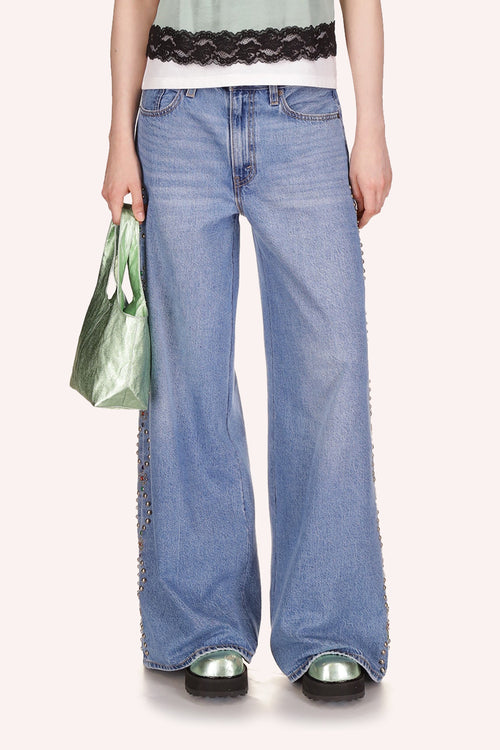 Denim, 2 pockets front/back, front zipper, wide legs over shoes, oval studded shapes, with silver/copper, top to bottom