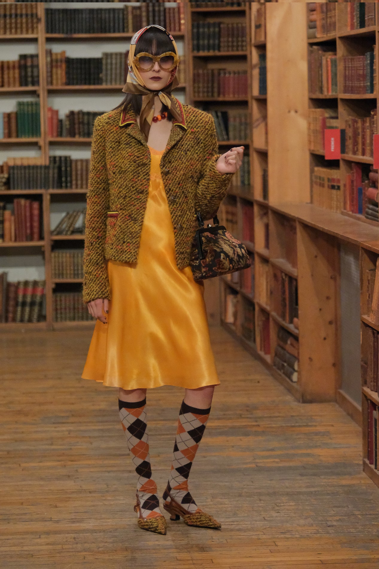 In a library presentation, The easy to wear Mustard Tweed Jacket brown/orange fall colors