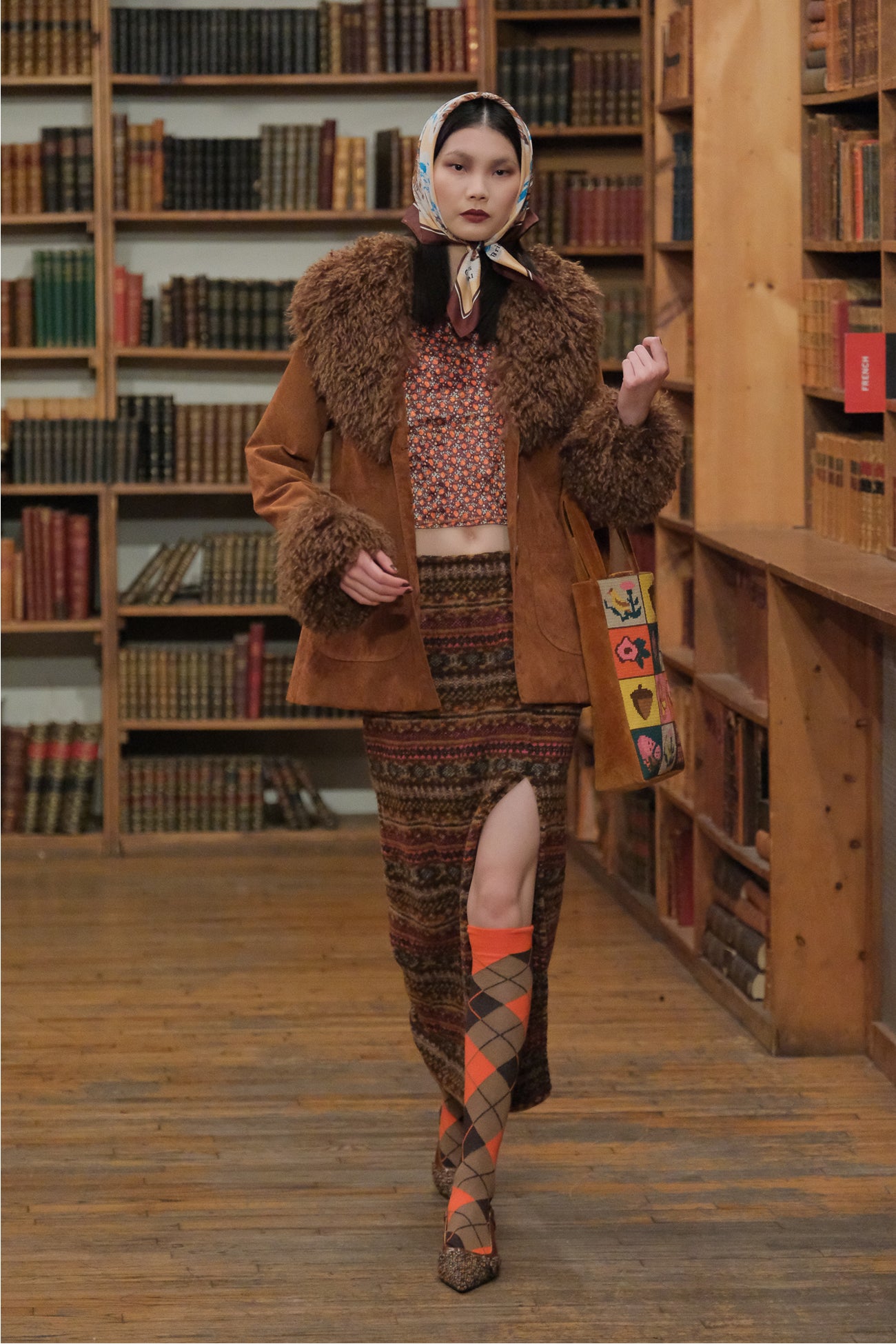 In a library, Needlepoint & Velveteen Tote Bag, cinnamon, paired with fall attire