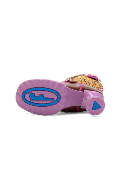 Fluevog’s signature sculptural heel sole in pink with a blue F logo in an oval.