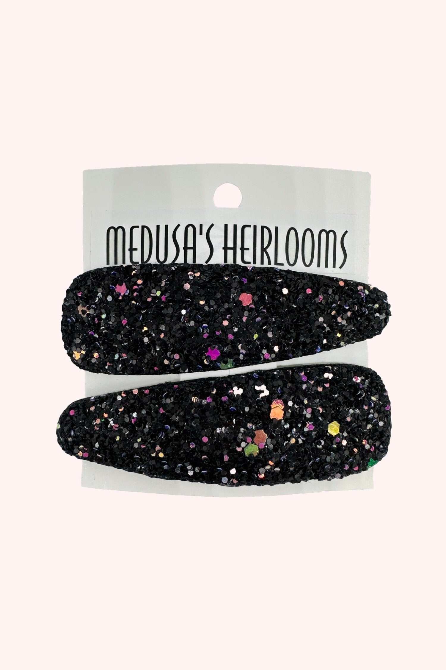 Glitter Snap Clip, pair of clip black with multicolored glitter on it, on “Medusa’s Heirlooms” display