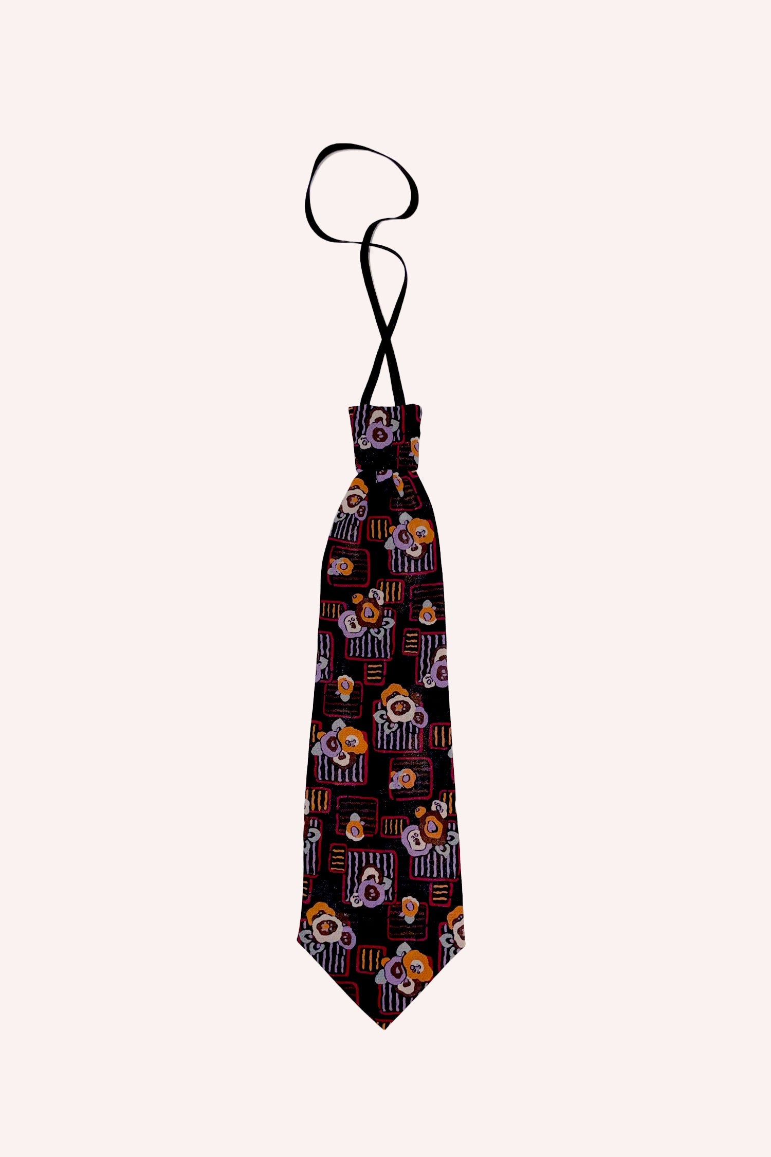 Deco Floral Patch Tie Orange, brown background, strap go around the neck, end in triangle shape
