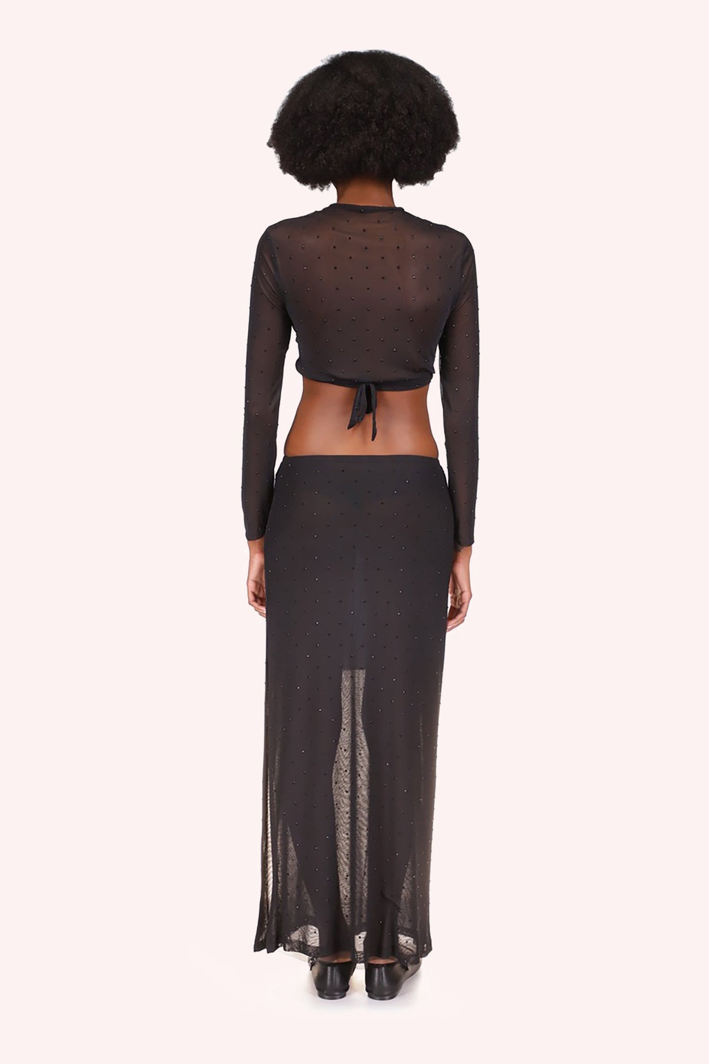 Skirt Black, transparent color mid-tight down, adorned with shiny black beads, ankles long