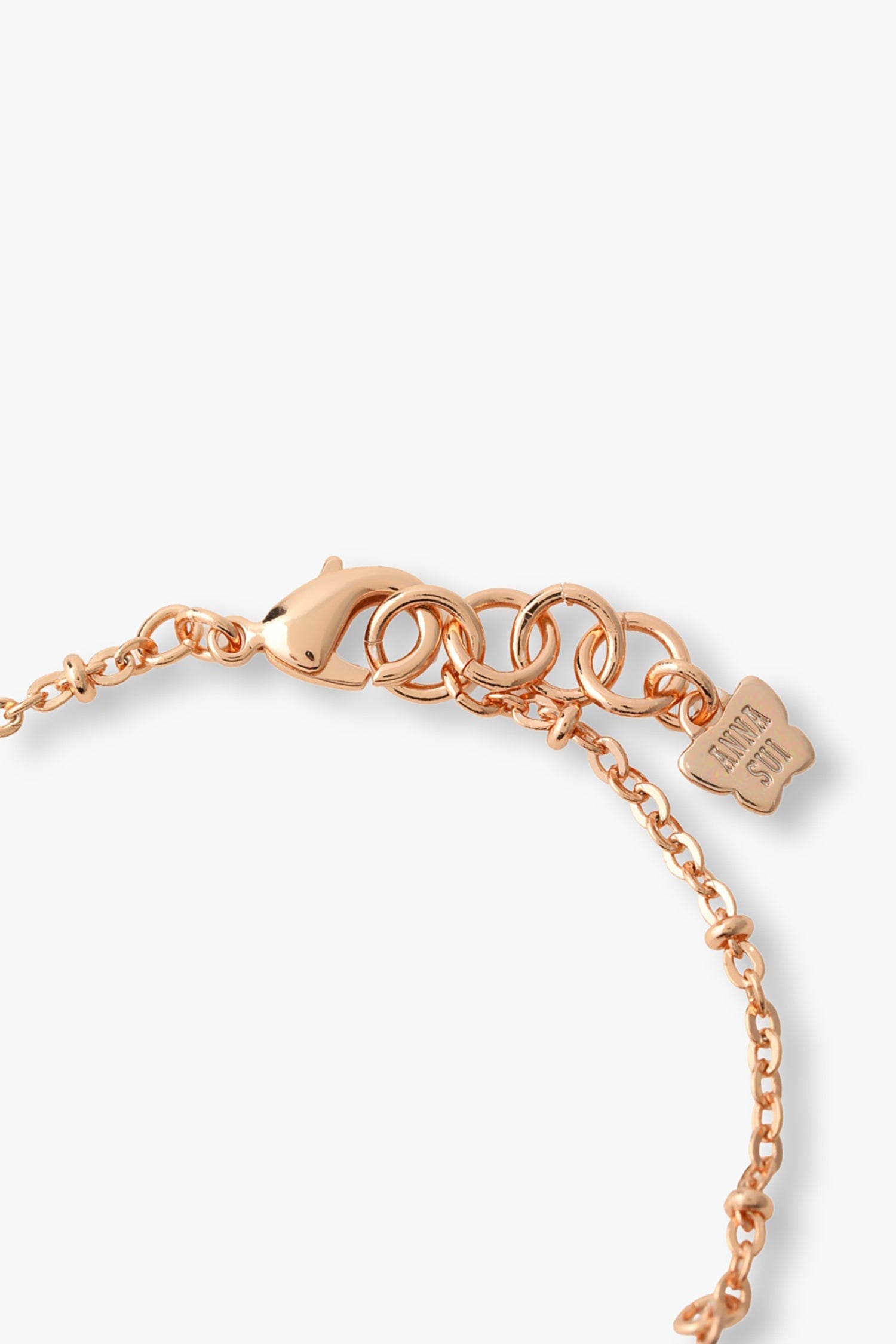 Rose gold lobster claw clasp with large links for adjustability, Anna Sui imprint on a tag