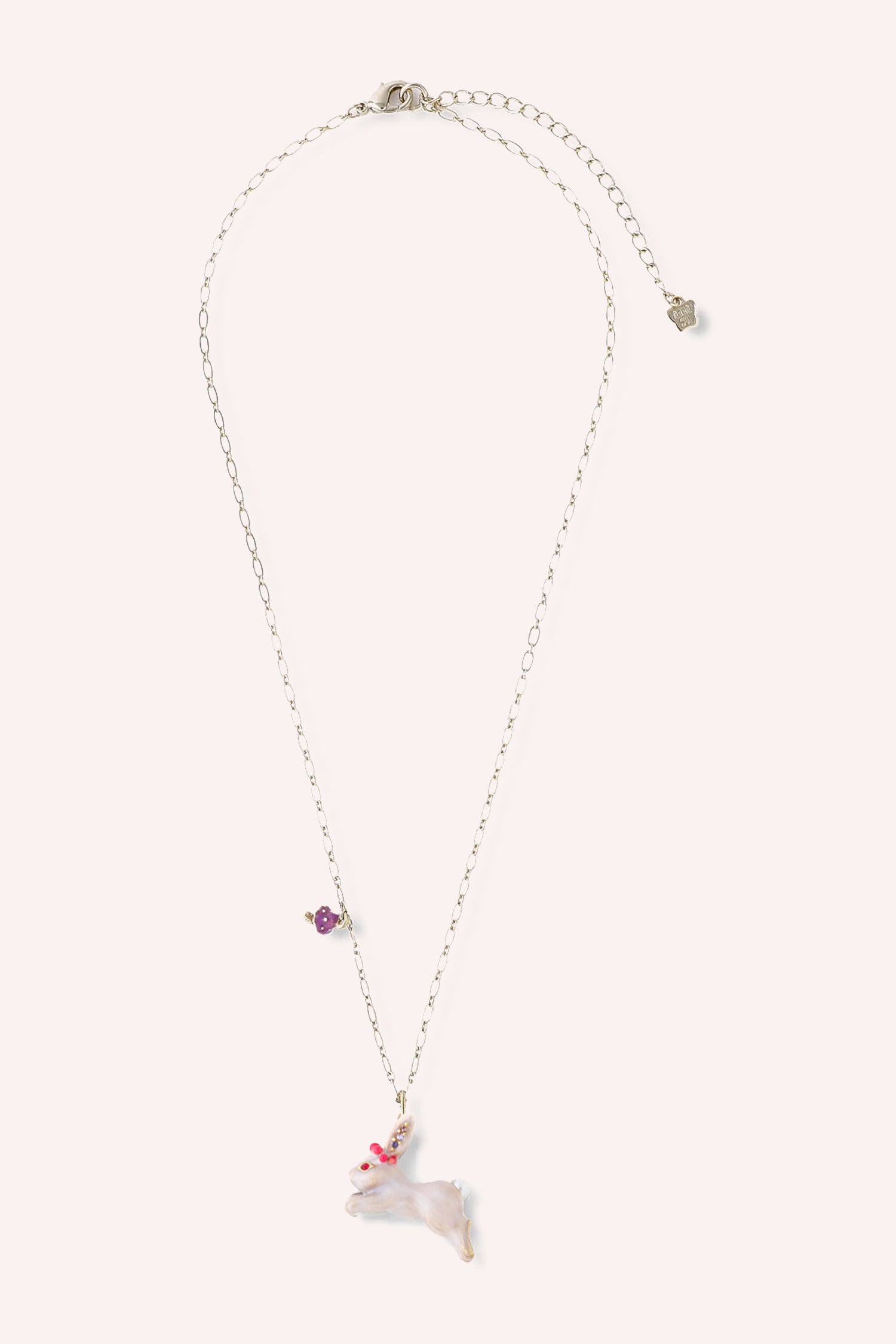 Necklace, Gold toned chain, white rabbit charm with red eye gems, purple ear gems, and red crown