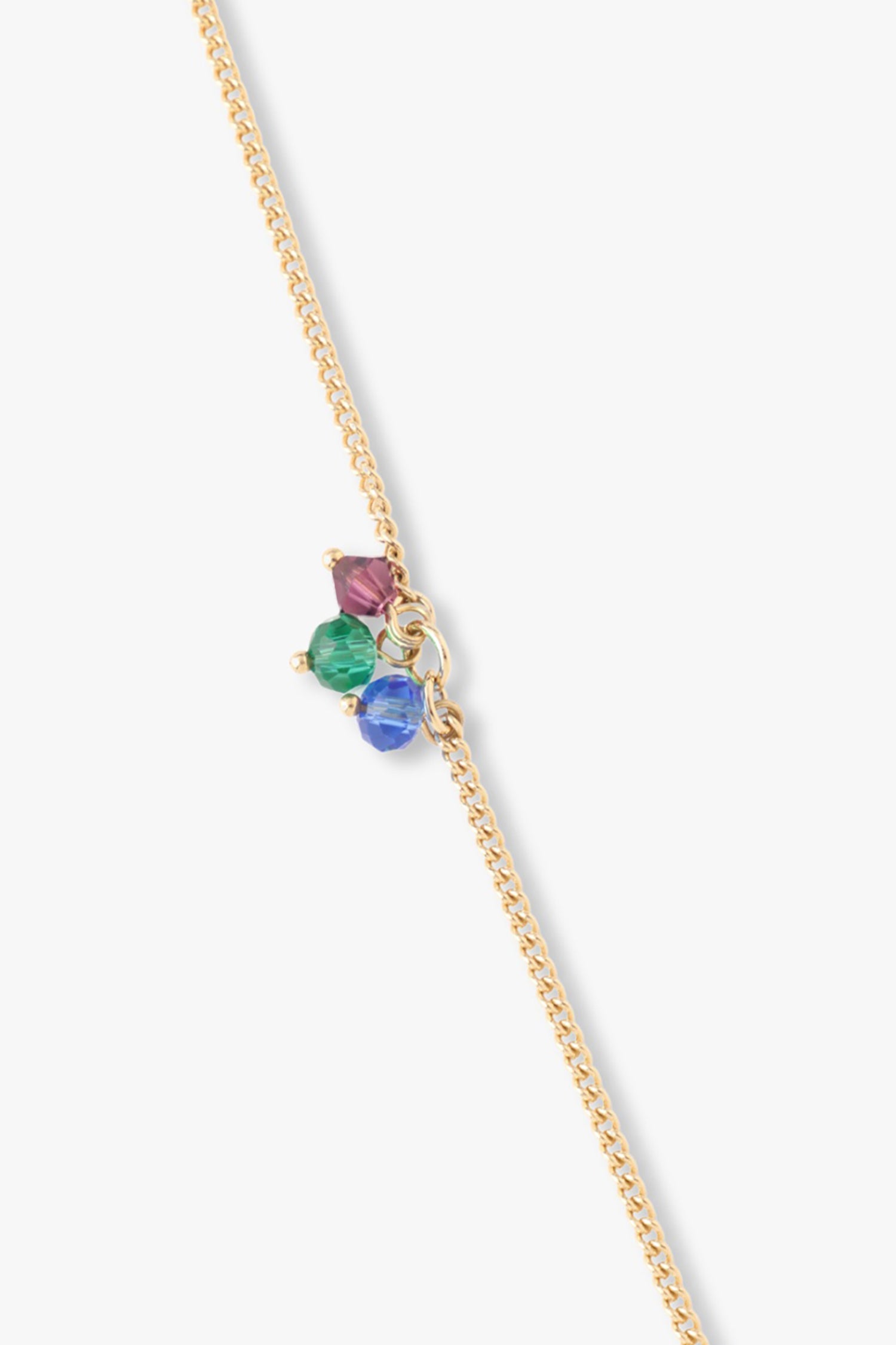 Detail of the hanging gem on the chain, red, green, blue, hanged on Lage links