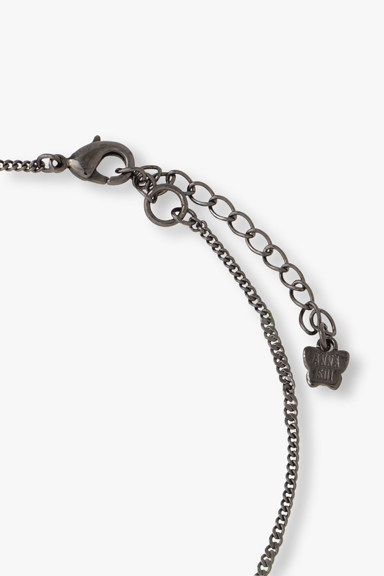 Gunmetal chain is with a lobster claw clasp lock, butterfly with Anna Sui imprint logo at the end