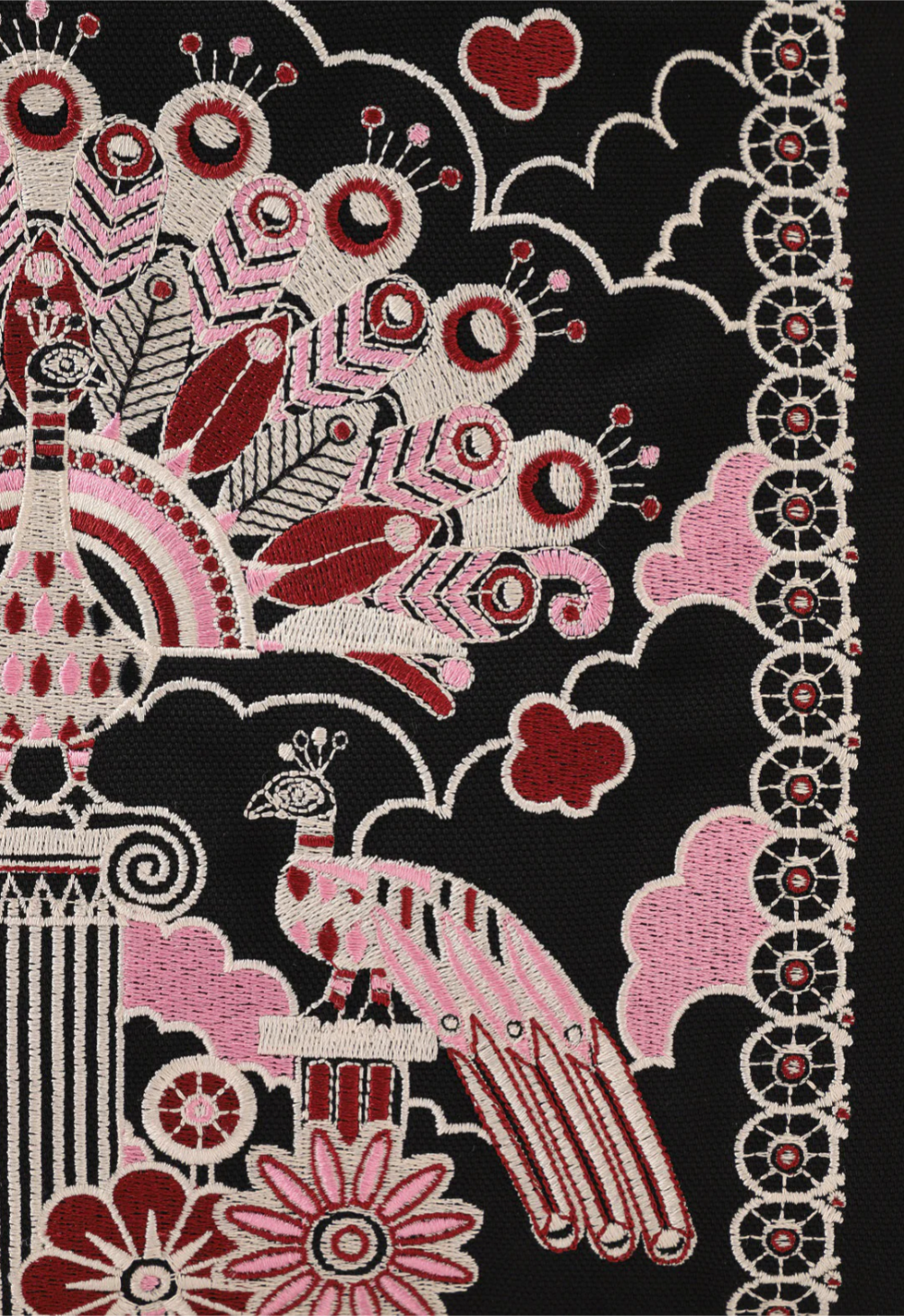 Detail of the large peacock art at the center of print surrounded by smaller pink and red peacocks