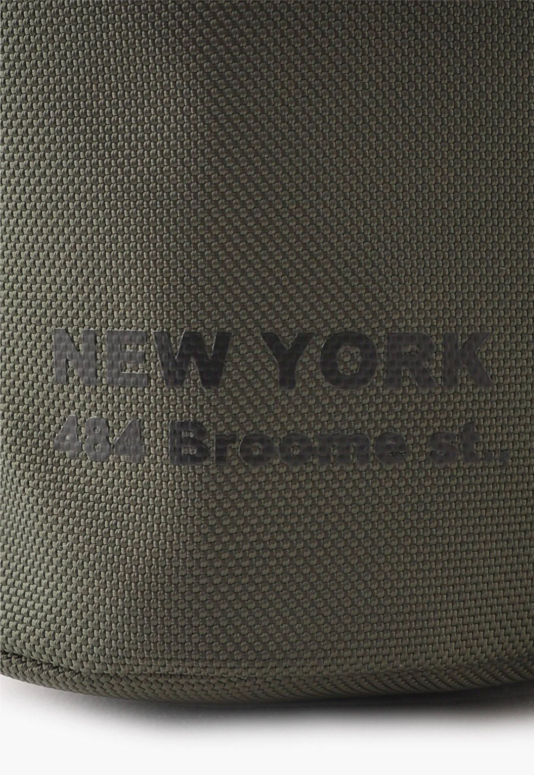 The Anyone Bucket Bag military green, on back detail of “NY 484 Broome sf.” Dark Green fonts