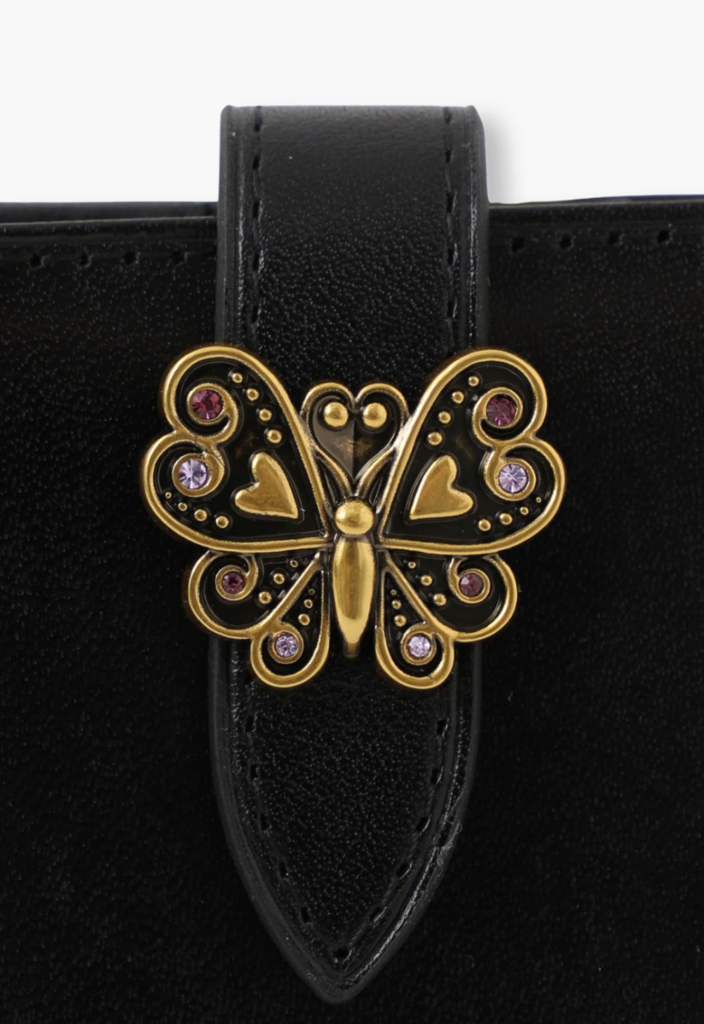 The Roger Wallet detail of signature Anna Sui golden butterfly hardware on the flap of the wallet
