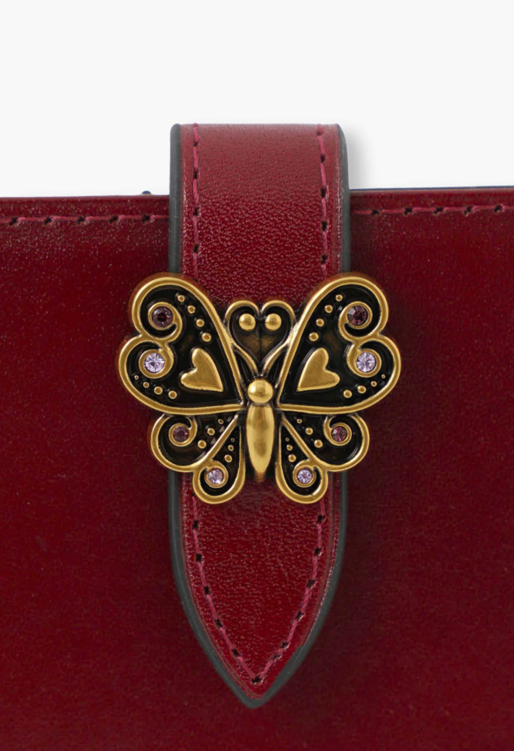 Roger Wallet wine detail of signature Anna Sui golden butterfly hardware on the flap of the wallet