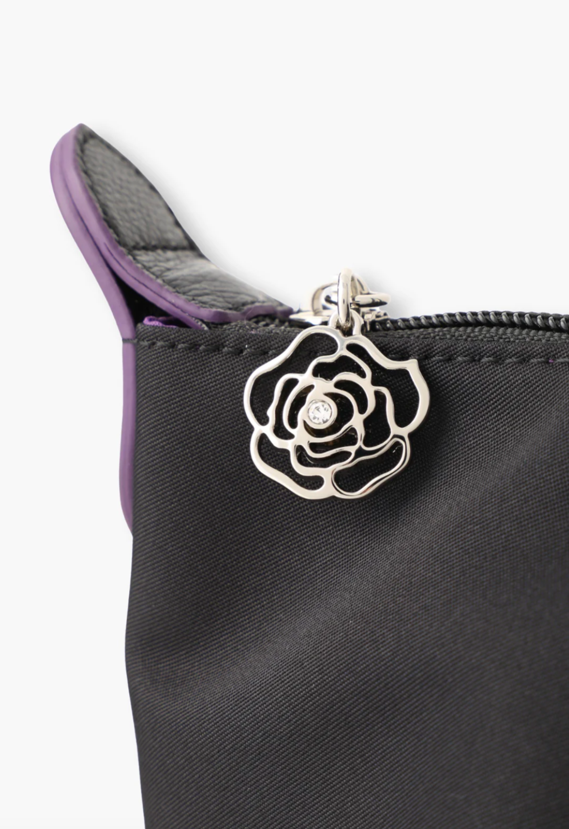 Voyage Tote, detail of the zipper-rose with a gemstone pull tab, leather horn, and the black stiches 