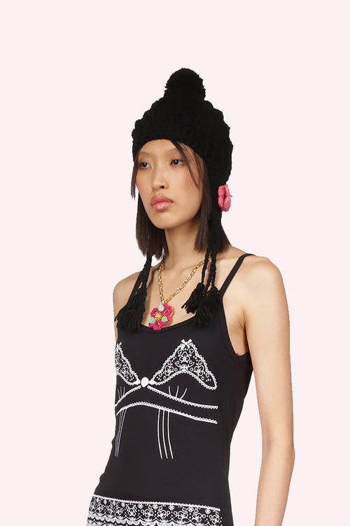 Black crochet hat with ear flaps, pom-pom, rose butterfly-shaped flaps, 3 strings per side, and bobbles