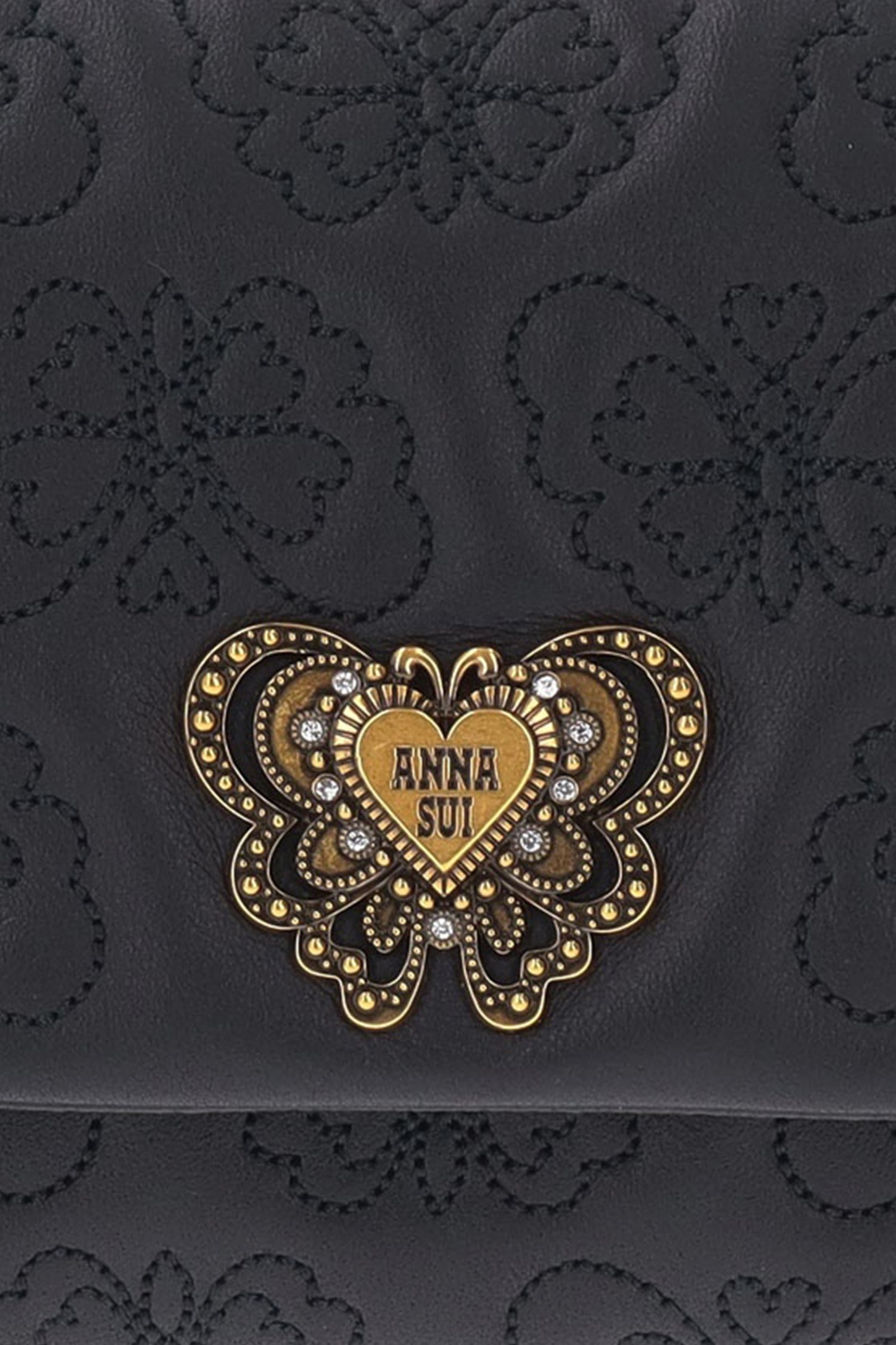Detail of Anna Sui golden and gems butterfly hardware on flap, Butterfly embossed on leather  