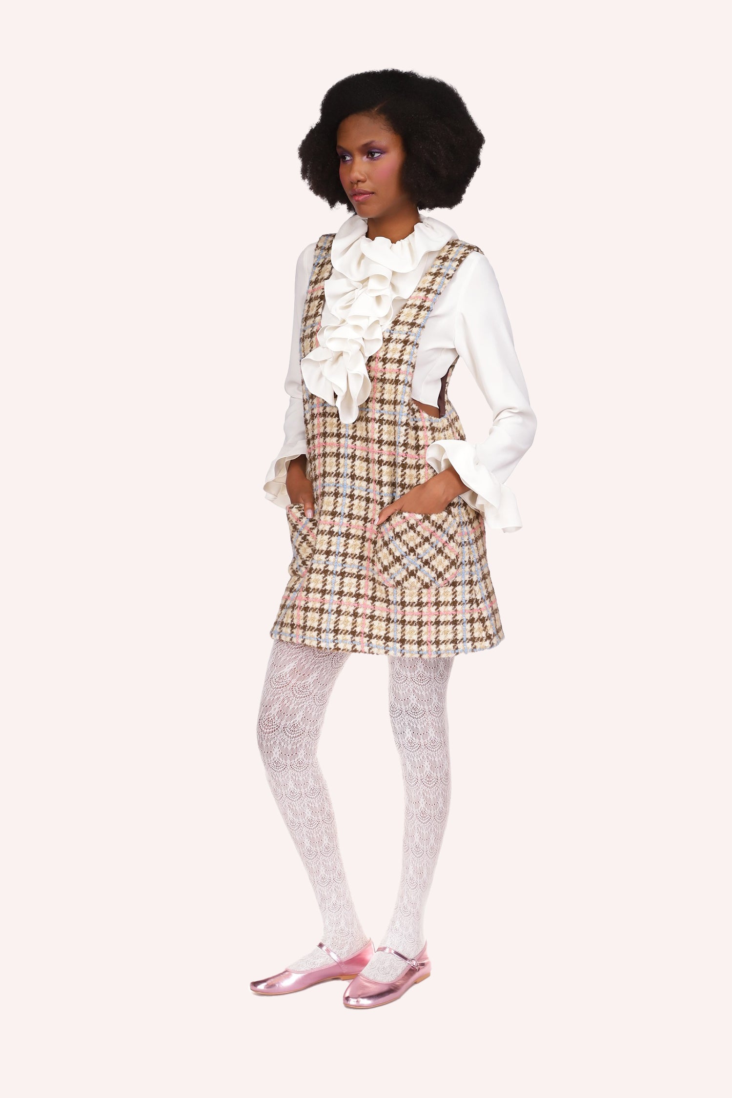 Houndstooth Plaid Jumper, background is beige with checker like lines in chocolate, yellow & pink