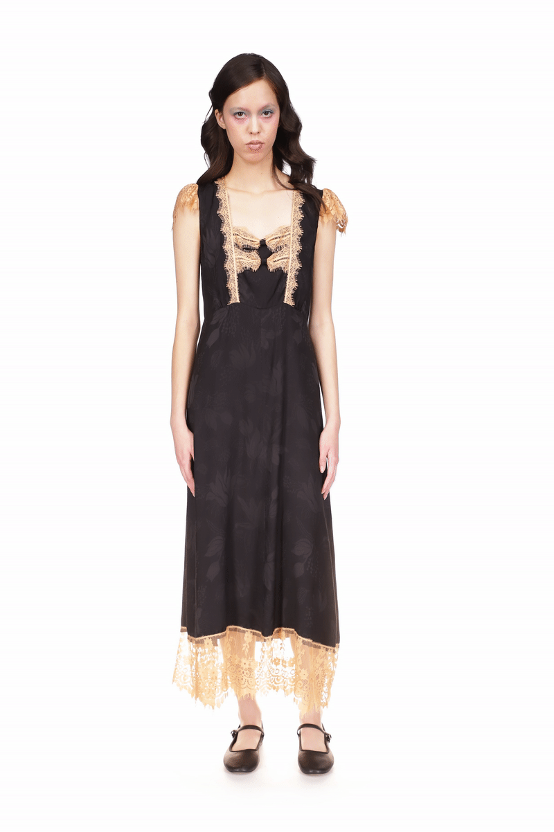 Dress black, beige lace covers top of the shoulders, wide band highlights the bottom of the dress