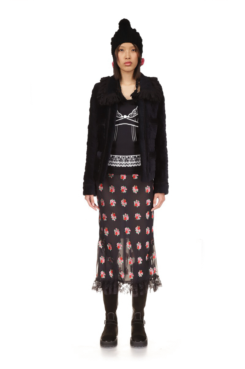 Black jacket, long-sleeves, large collar, 2-large pockets and shiny black opening and a repetitive, daisies-like pattern