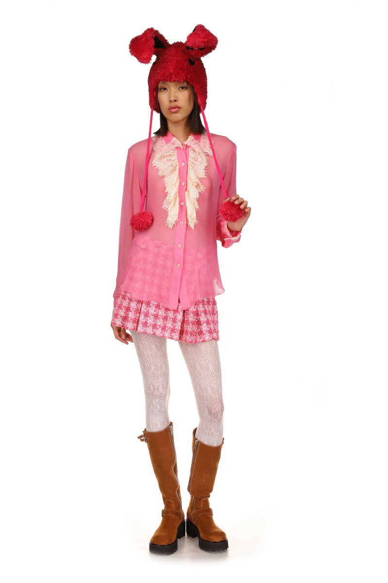 See-through rose-colored fabric, long sleeves, distinctive fluffy chiffon-like collar, 7 white buttons, v-cut on hips