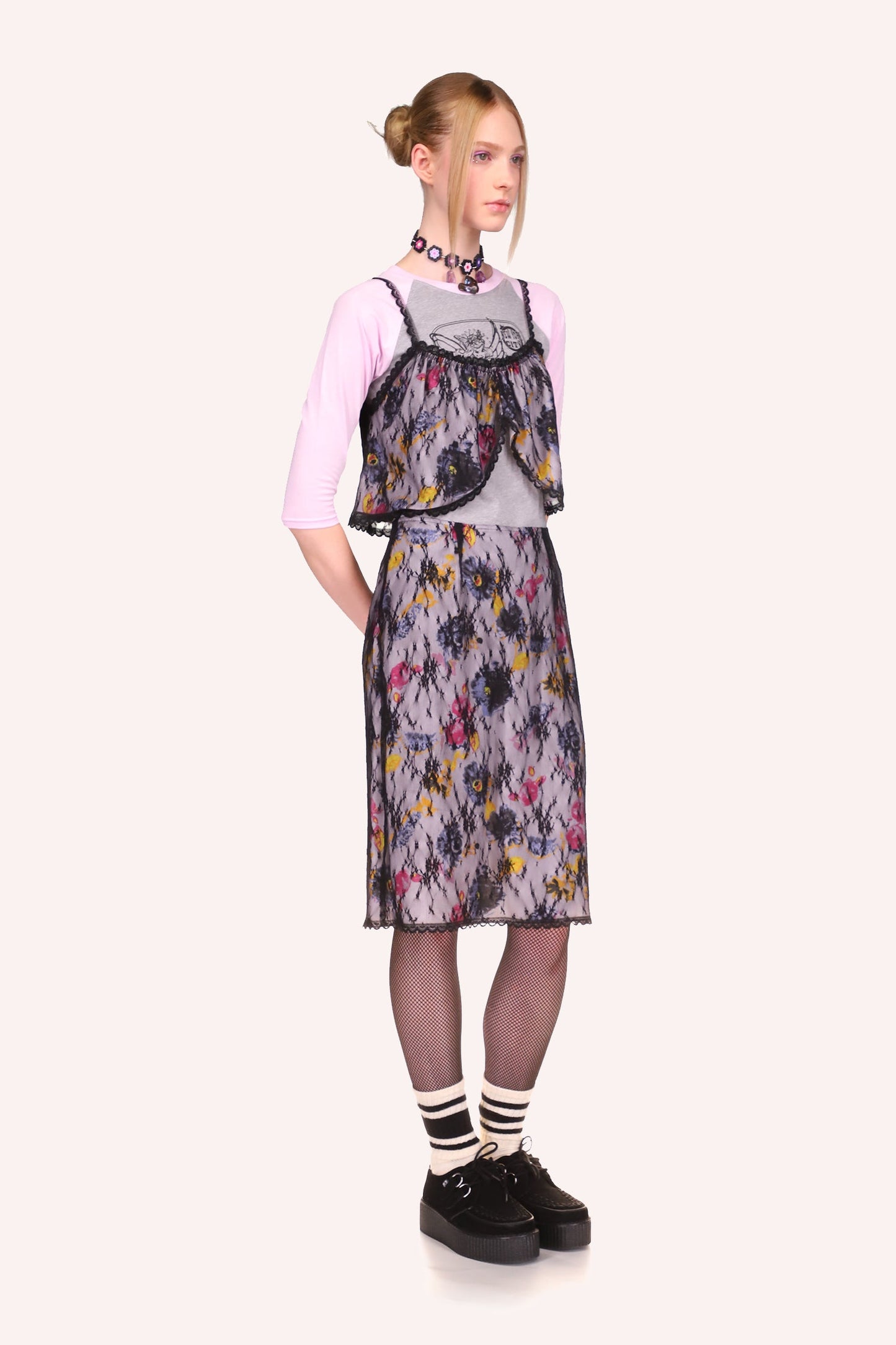 Knee-long skirt, pattern of lilac, pink, and yellow colors flowers, bottom, and side hems in black lace