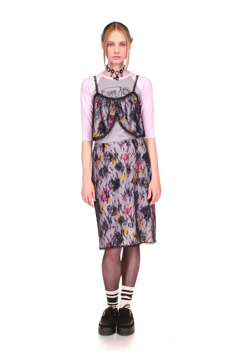 Knee-long skirt, pattern of large lilac, double pink, and yellow colors flowers, bottom, and side hems in black lace