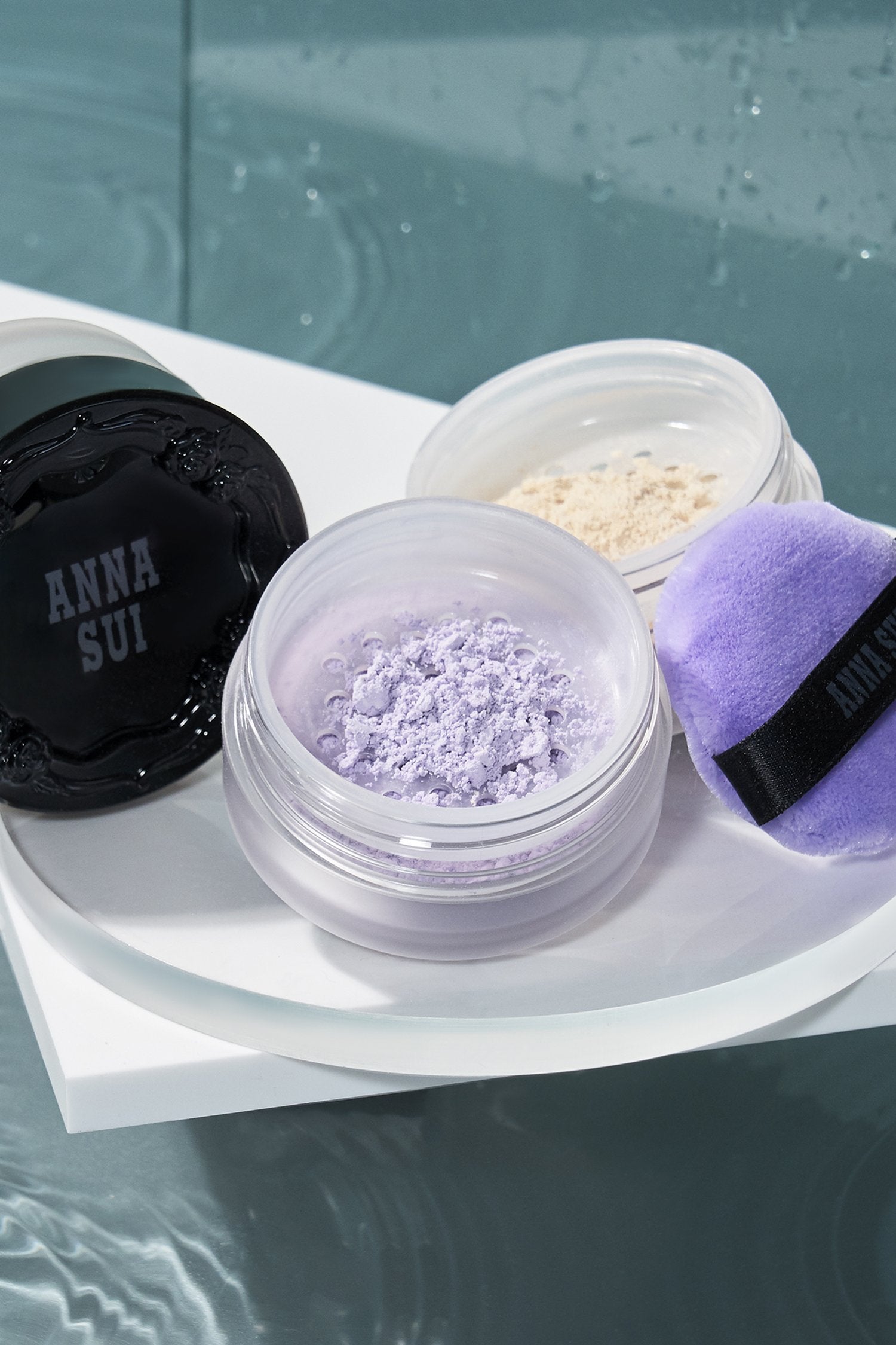 LIGHT PURPLE powder, open case, purple pad, black lid, raised rose pattern, Anna Sui in a bevel