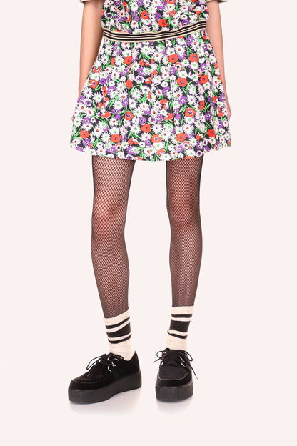 Daisies Skirt Rouge is mini, with a pattern of white daisies with green leaves and red spots