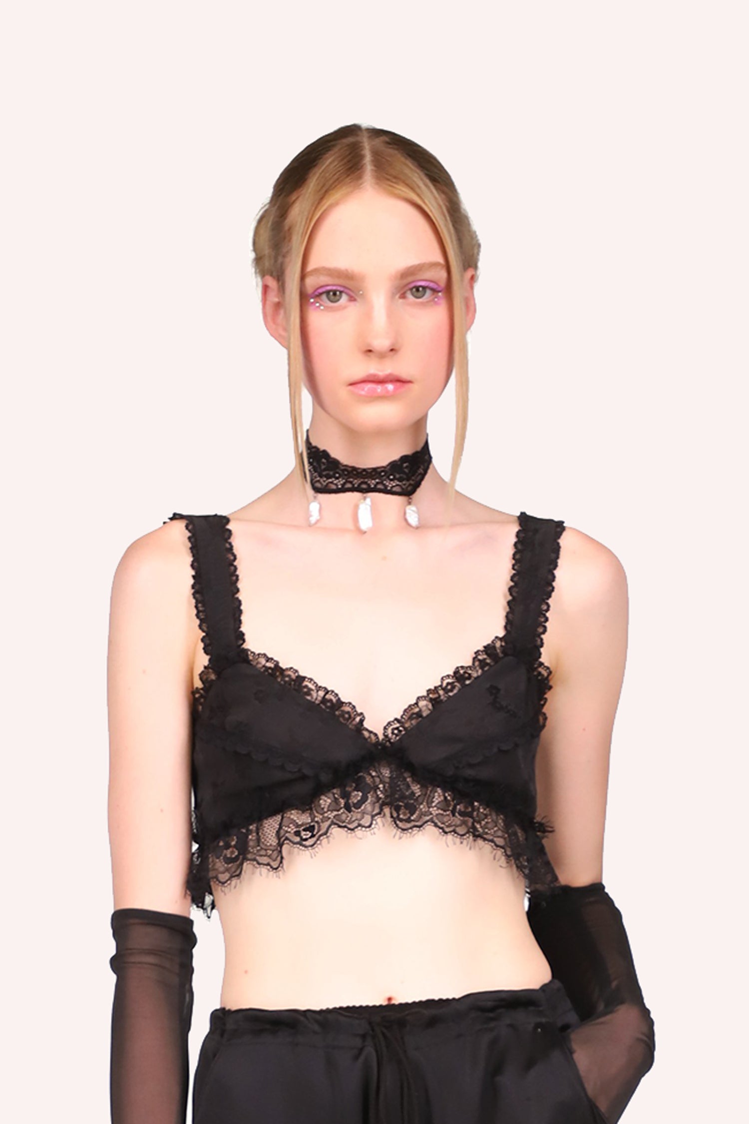 "Floral Jacquard Bralette" is a black-colored bra with a large lace hem and two straps with smaller black lace.
