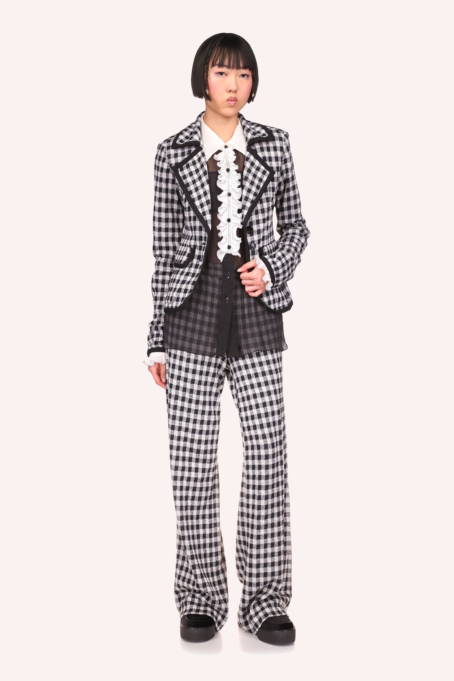 Checkered in B&W, black seams, a wide collar with a V-shaped flap, enhance your curves