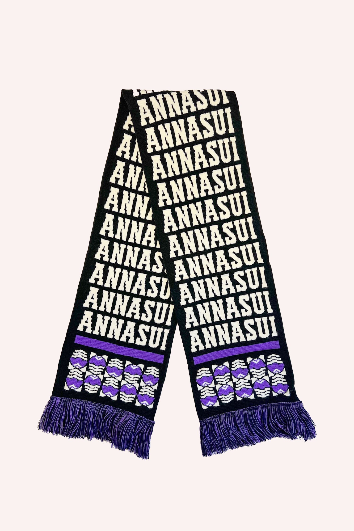 The Scarf in black with pattern Anna Sui, with purple fringes beneath a stylized egg design, and a purple line on both ends