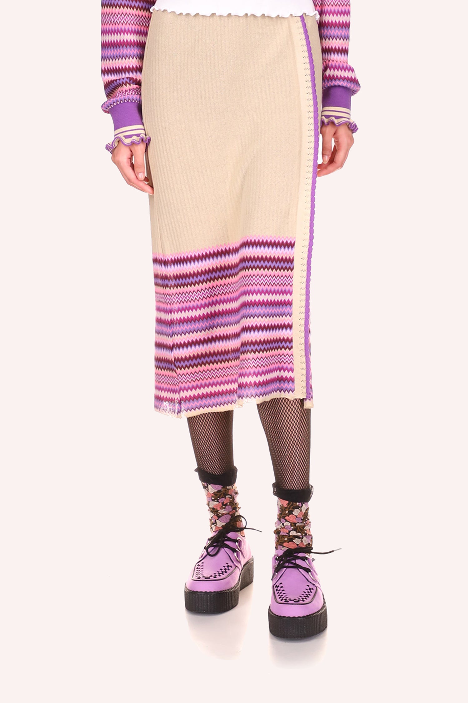 Mid-calf beige skirt, zigzag patterns, hue of lavender at the bottom, a slit that goes up to mid-thigh