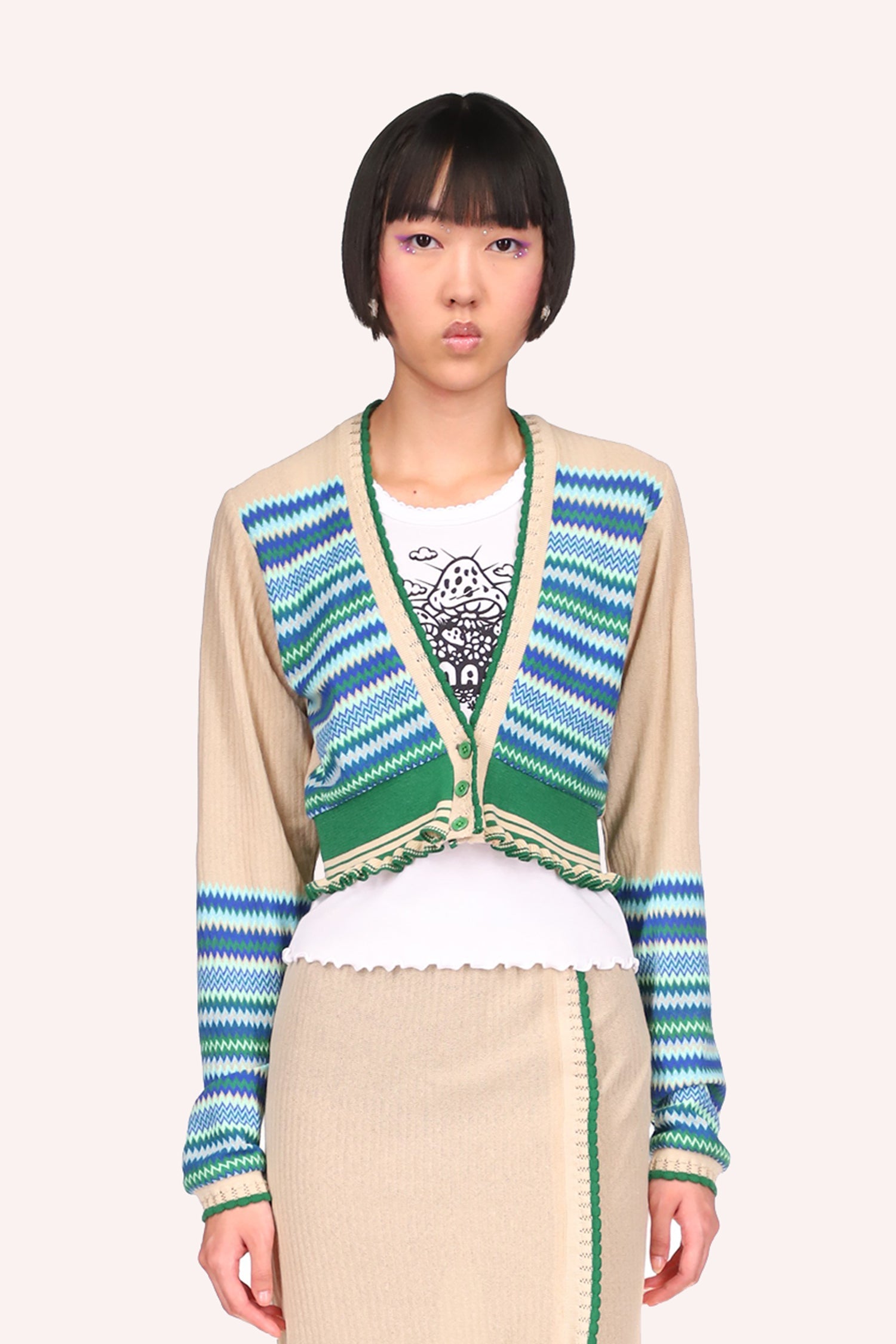 Cardigan Cornflower, above hips, long sleeves, deep V-cut collar 3-green buttons, up at center.