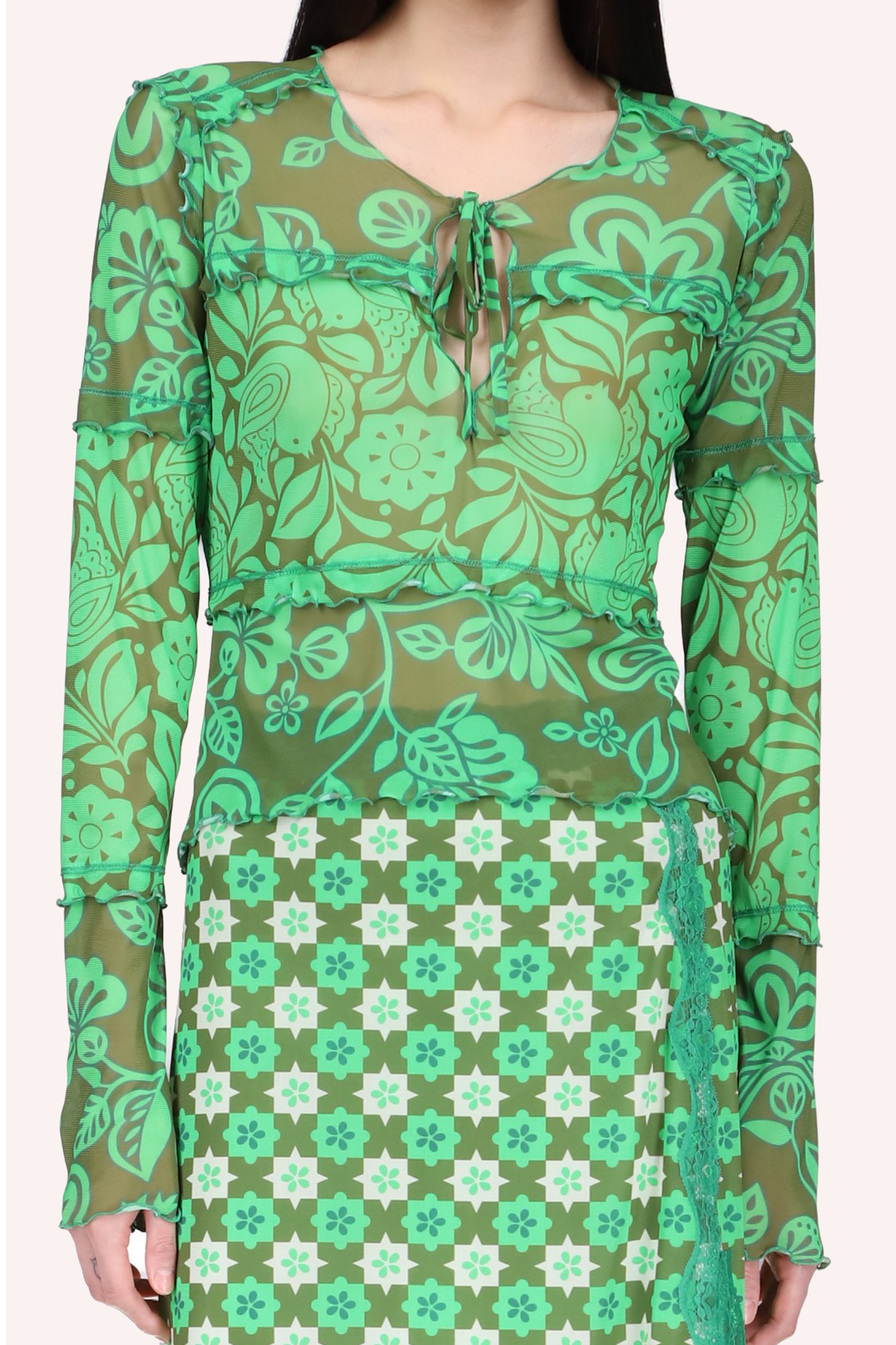 Top is glo green, long sleeves, floral design on transparent mesh, ribbon knot to close the V-collar