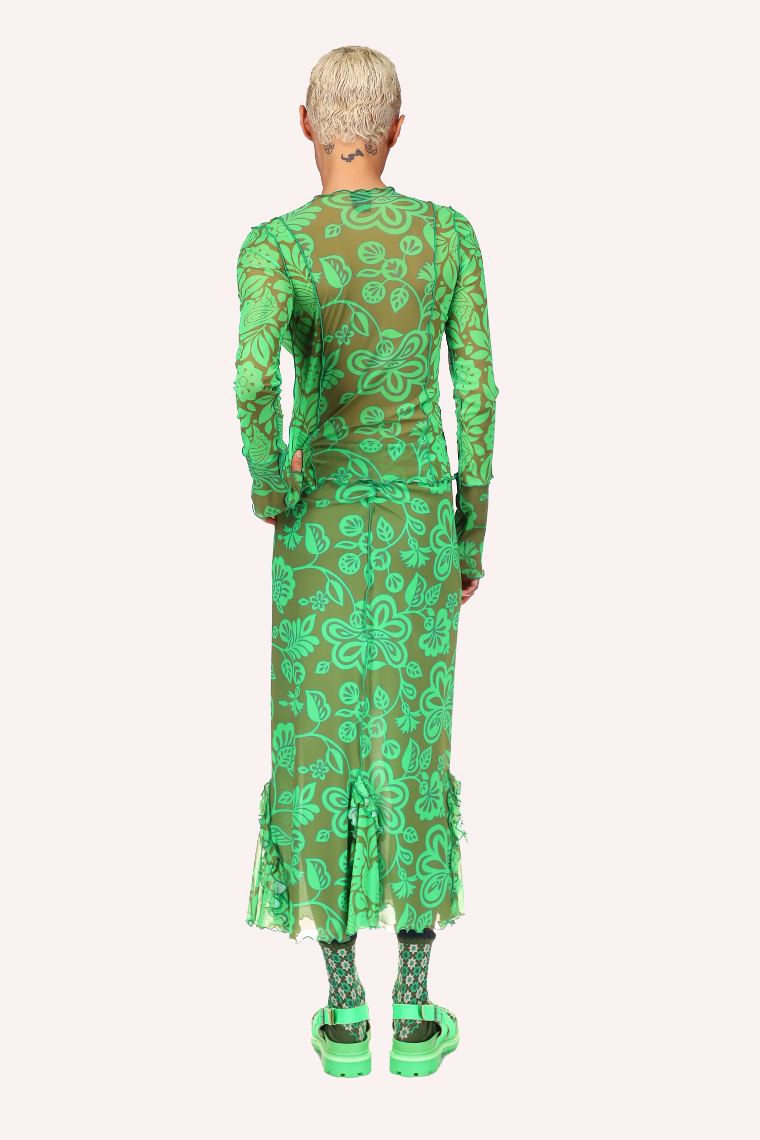 Long green stiches on the back and green ruffle at bottom, ankles long
