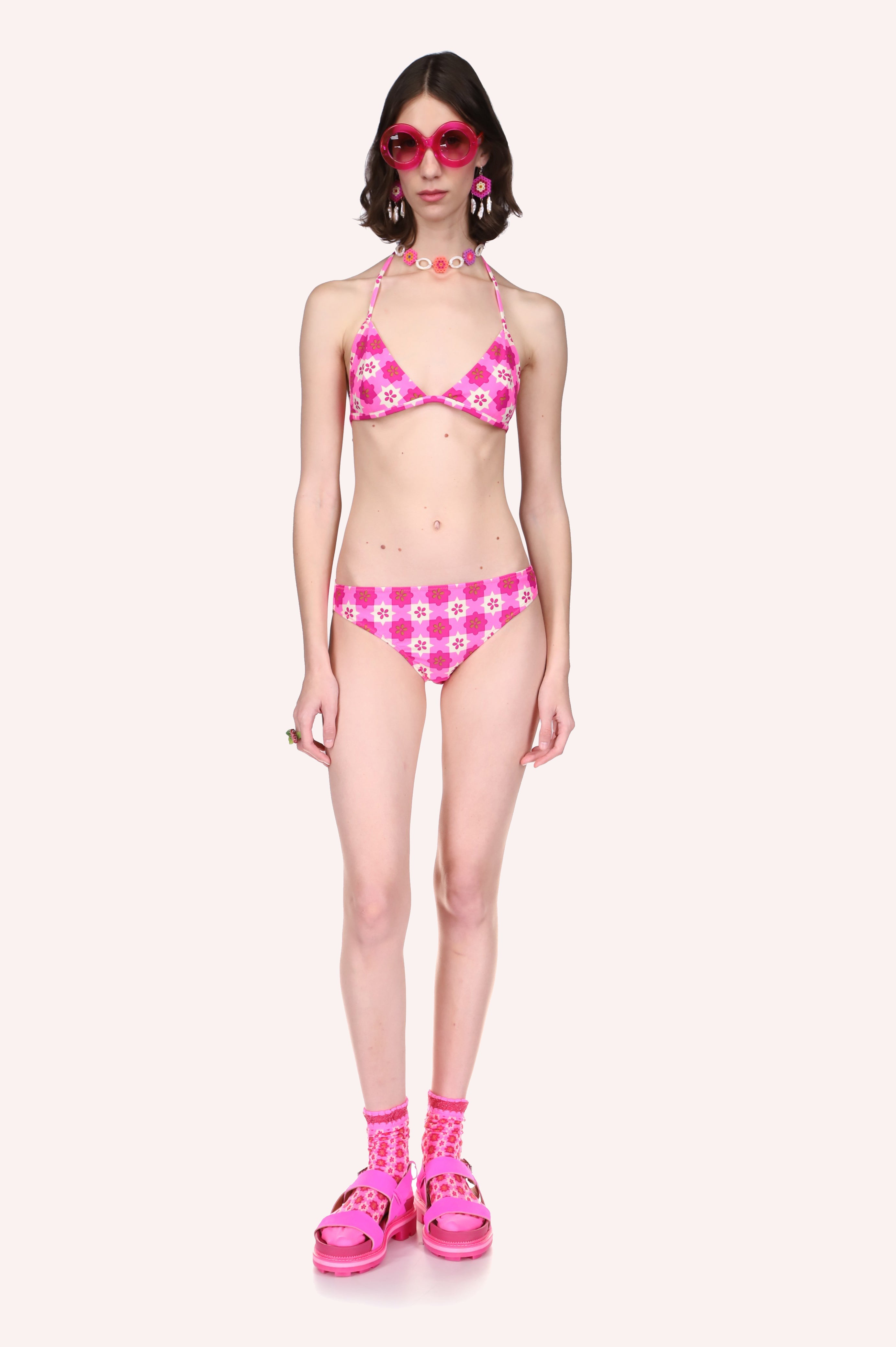 Utopian Gingham Triangle Bikini Set Neon Pink features a pink and white star-shaped pattern.