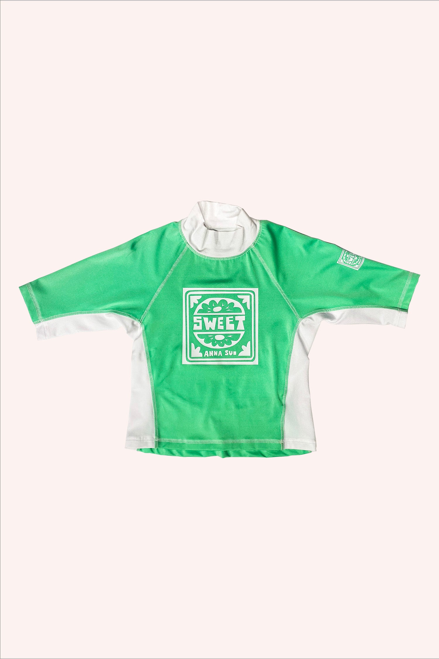 Top, Glo Green, a print in front, white on green, in a square a round stylized flower with a cap word SWEET and A.S. label