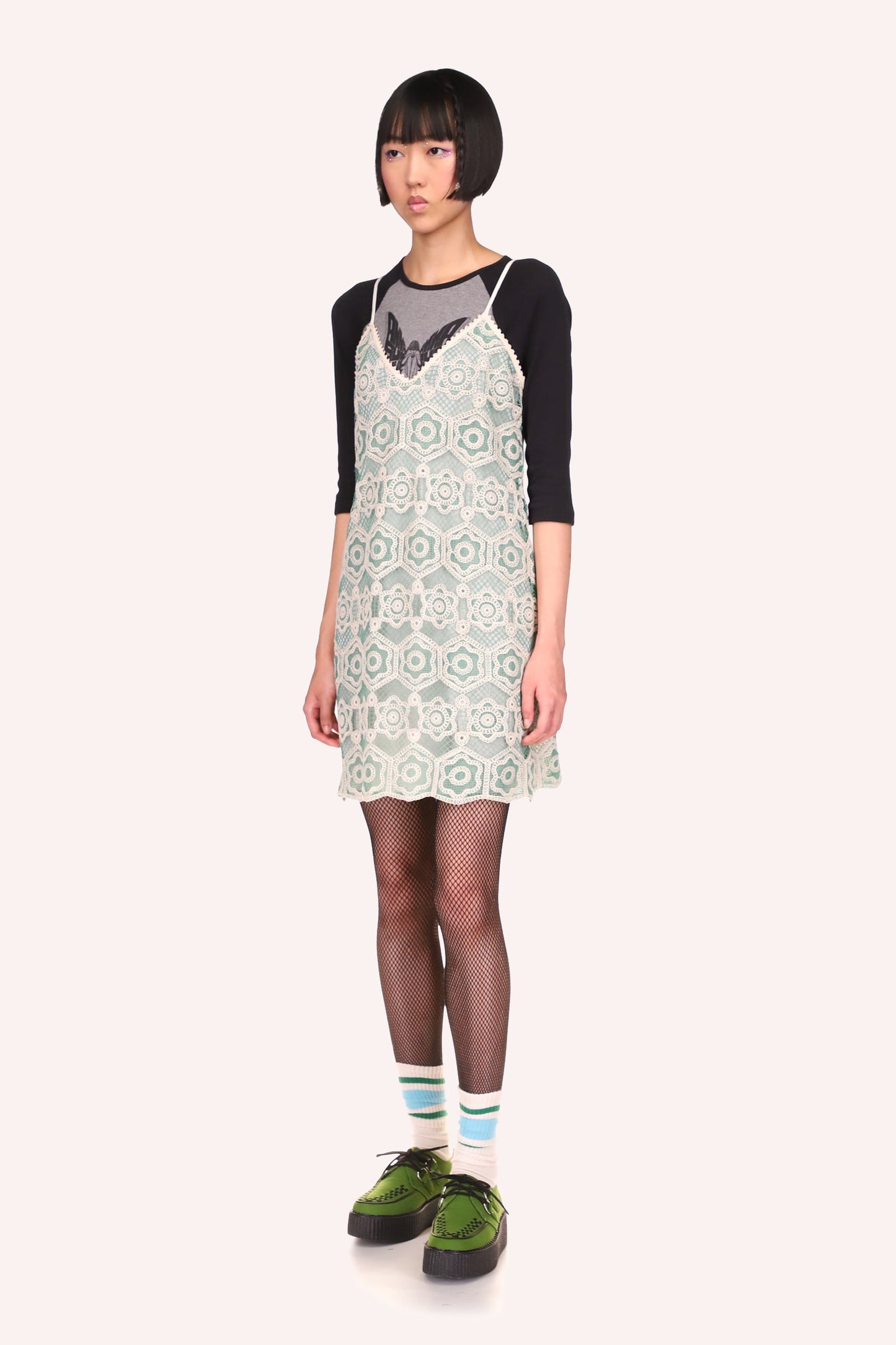 Dress collar V-shaped, lace texture in stylized hexagonal, from light green to darker shades of it