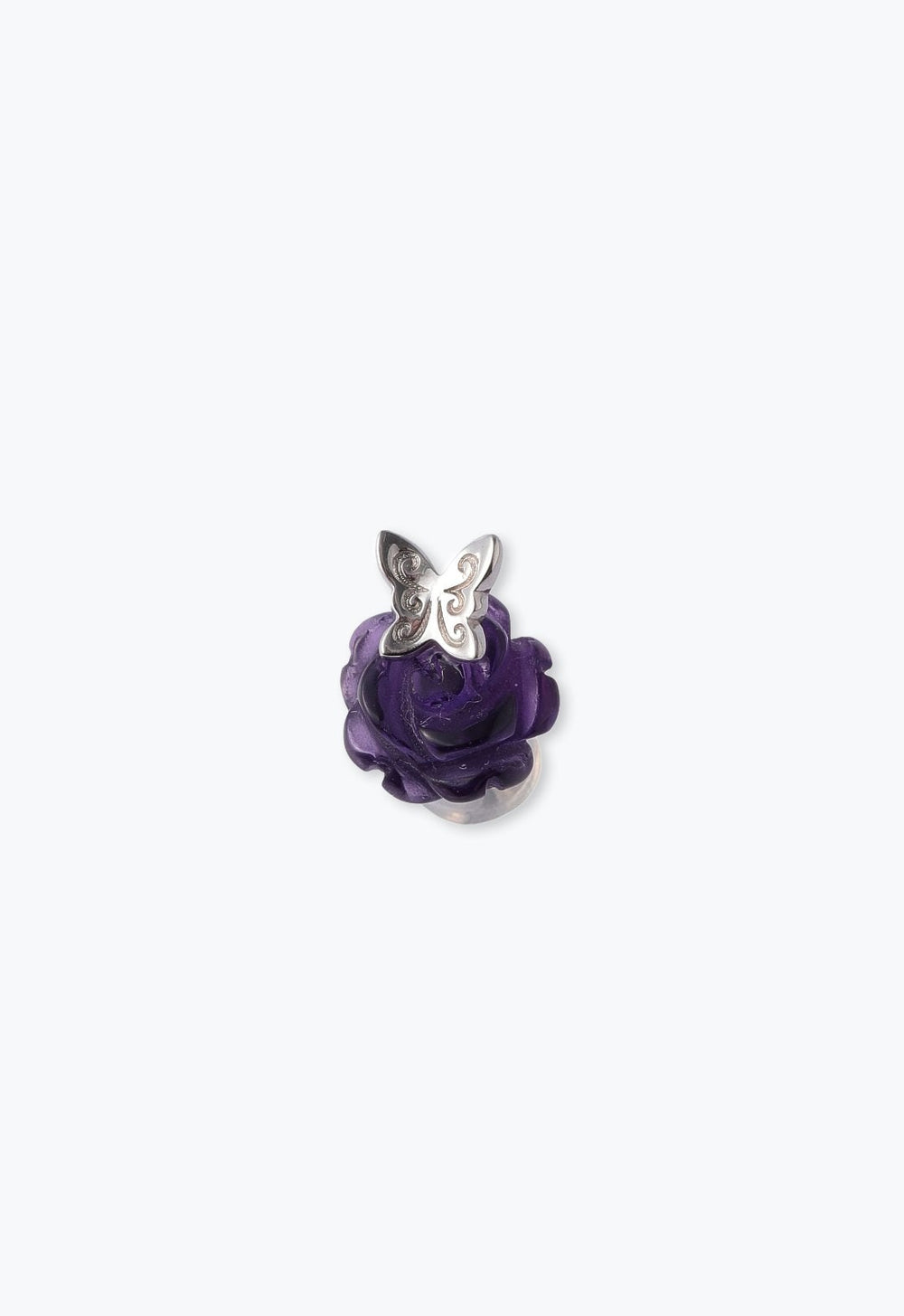The stylized silver butterfly is positioned on an amethyst rose with a more realistic cut