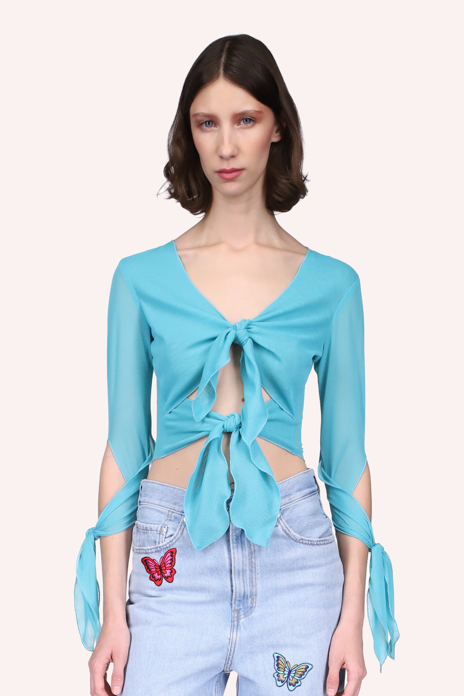 The Gisele Top Seafoam, fastened with 2 ribbons in the front and one on wrapped each arm