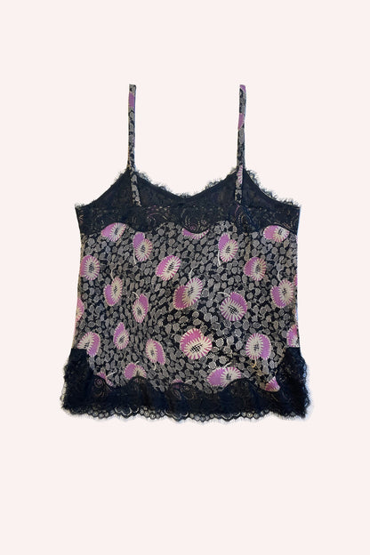 Black background, white & pink flowers on grayish leaves, black lace stitching accentuating design