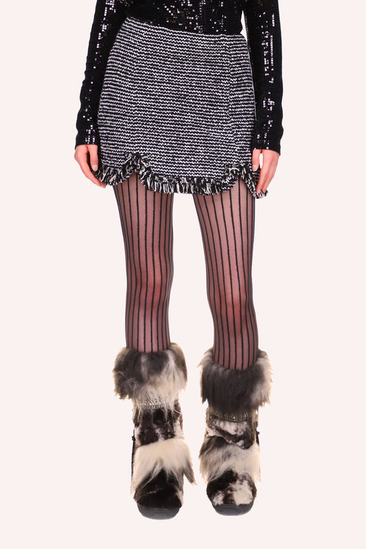 Skirt is mini in black & white tweed, fringes on the bottom hem and a small round slit at thigh level