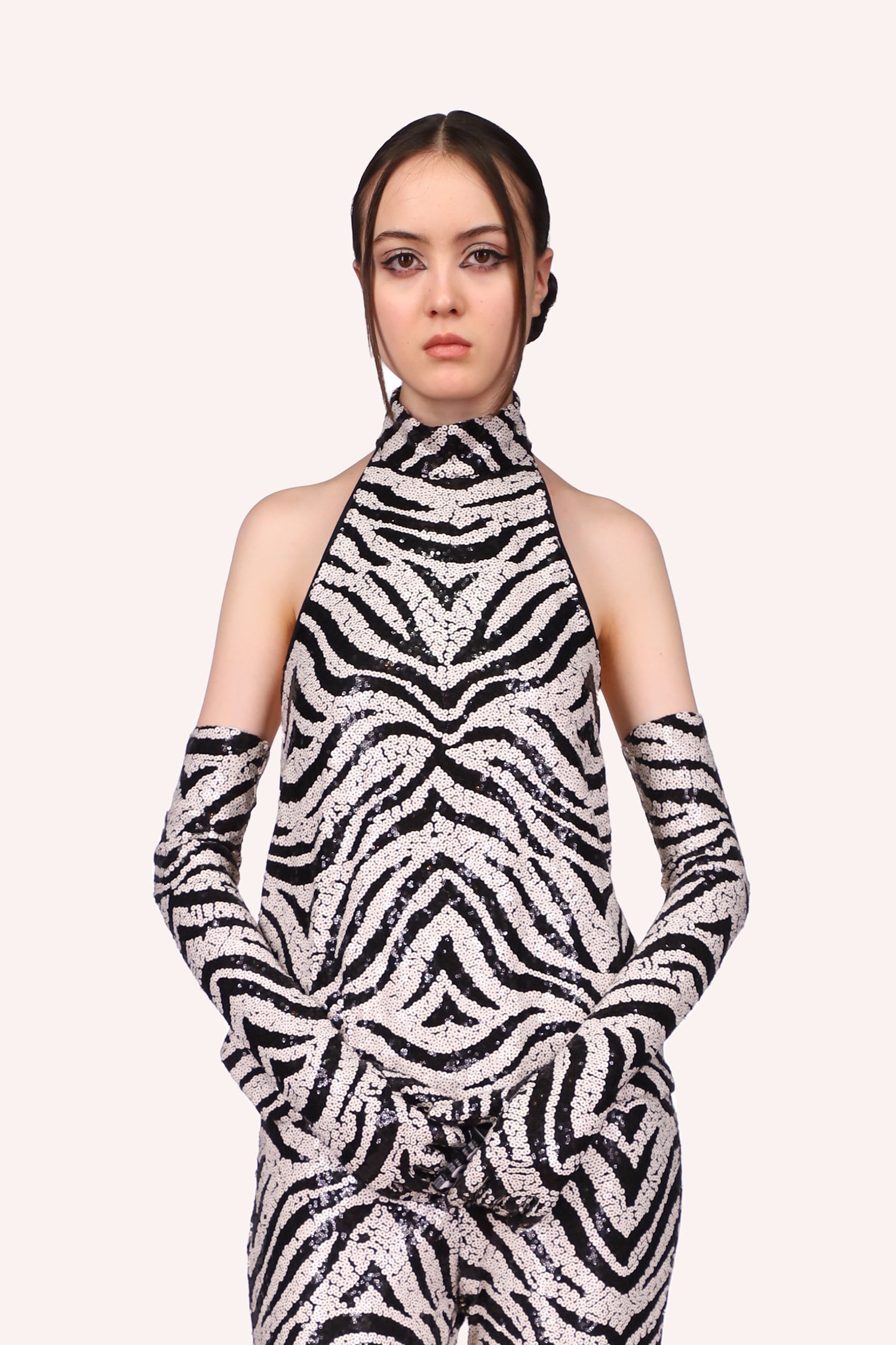 Top sleeveless, front goes up to a turtleneck, the design is in black and white as a zebra pattern