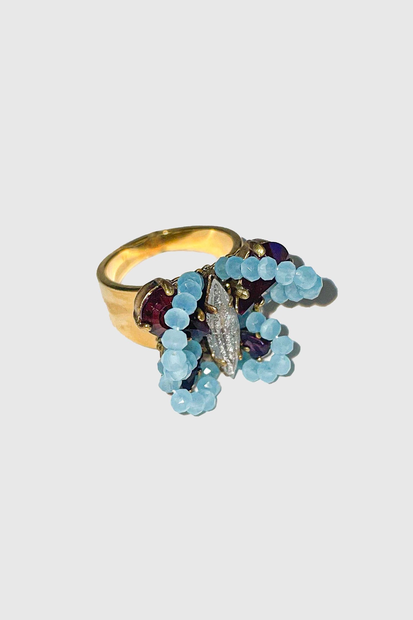 Butterfly ring with baby blue beads, body with an oval gemstone, dark red wing