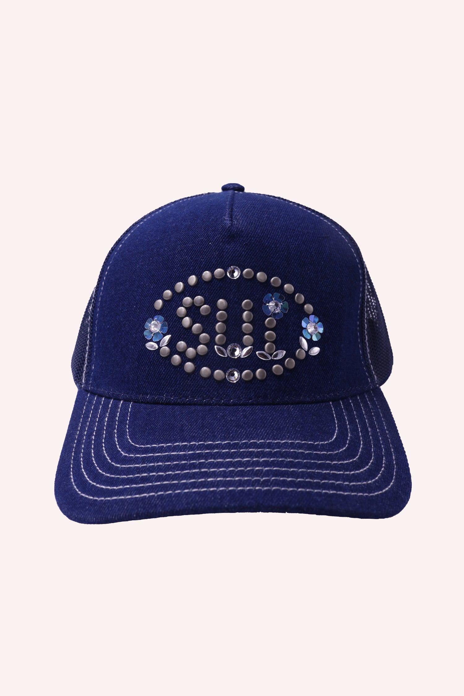 Studded Sui logo inside an oval with a floral design on each side of it, U with floral bottom, I with a floral dot