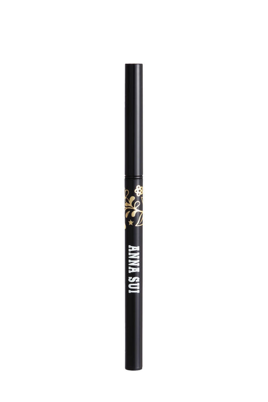 长圆柱形容器中的眼线笔，带有金色花朵图案和白色 Anna Sui 标签