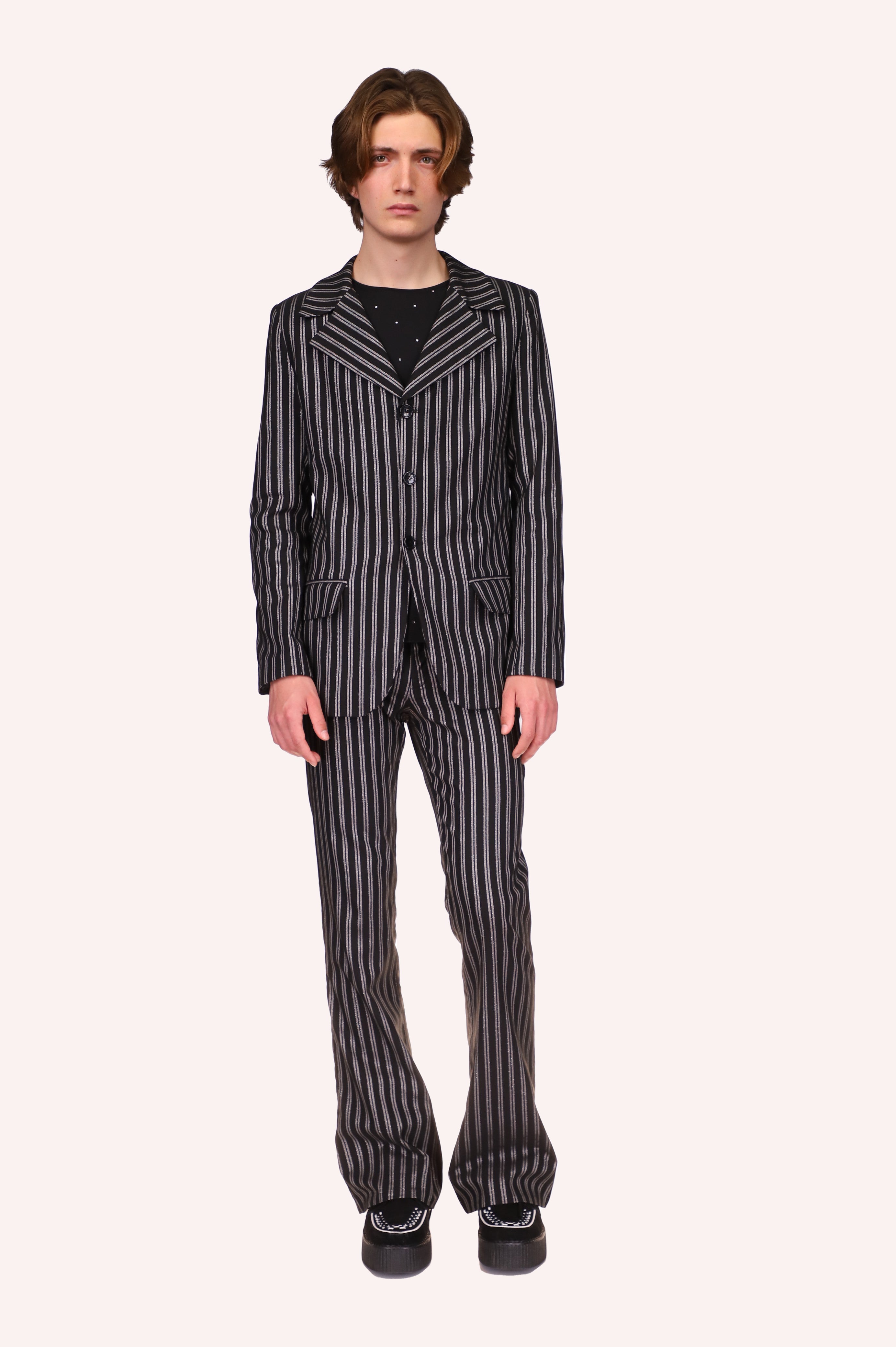 Pinstripe Jacket Black is part of a suit, the pockets of the suit have flaps, round cut bottom center