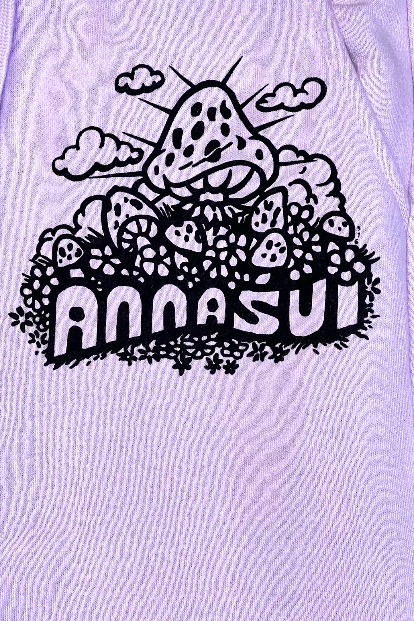 Anna Sui mushrooms label, black and white, big puffy mush above other and under clouds