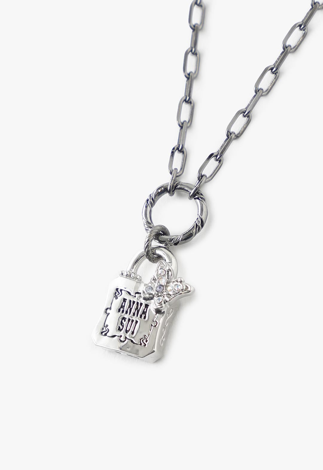 Details of the Wrath Ring include a polished silver chain linked with a glass butterfly and the Anna Sui logo on the lock