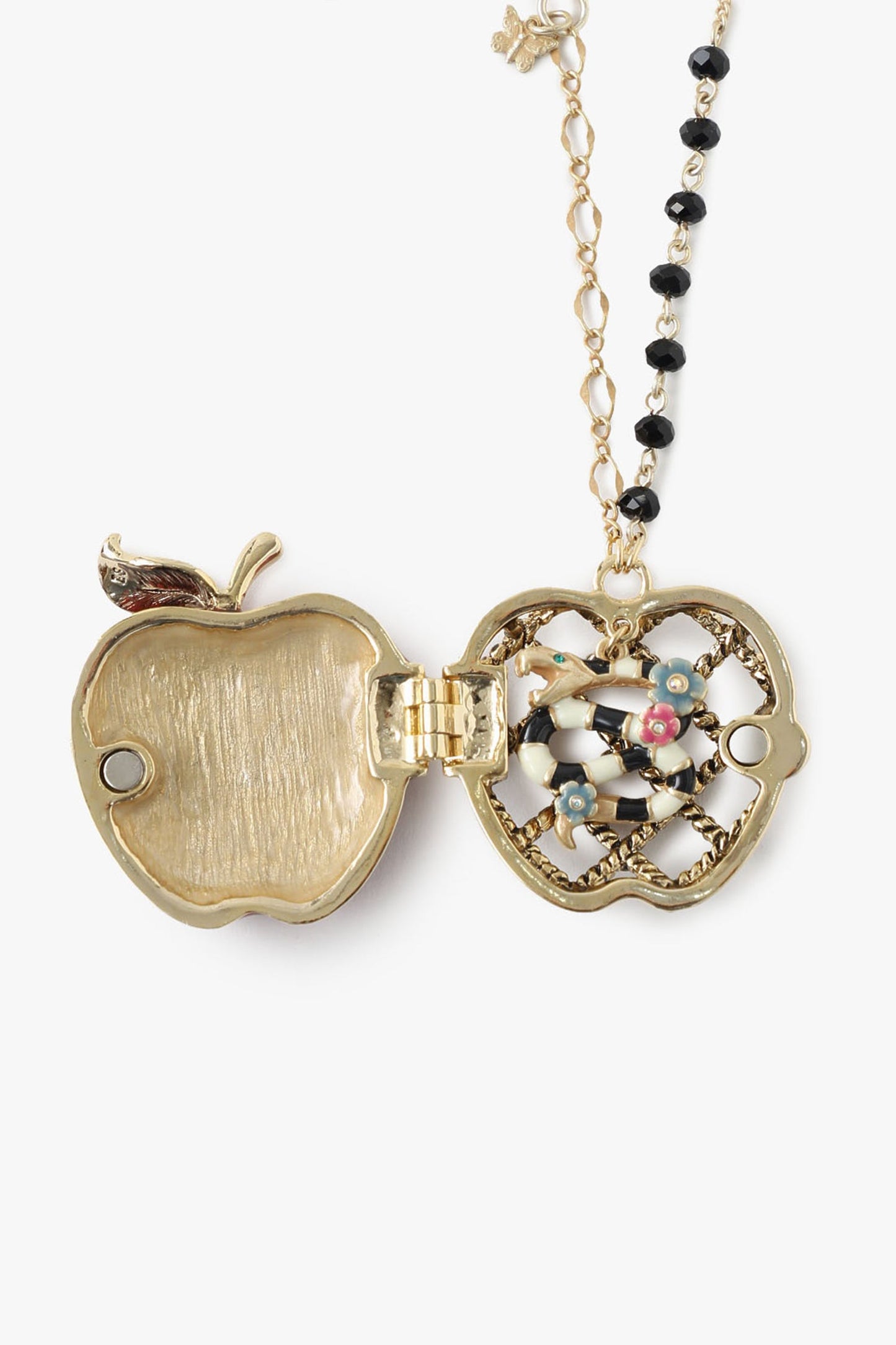 Red Apple Necklace is a locket, closed with magnet, inside is a black/white snake with golden lines